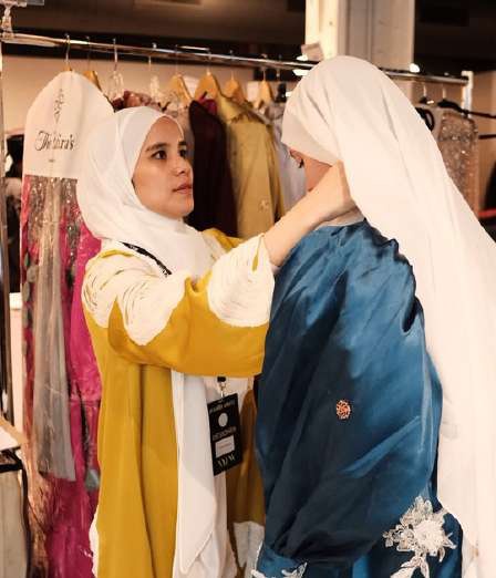 Final adjustments to the abayas backstage before the NYFW presentation