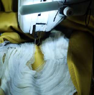 Sewing the wave details on mustard fabric